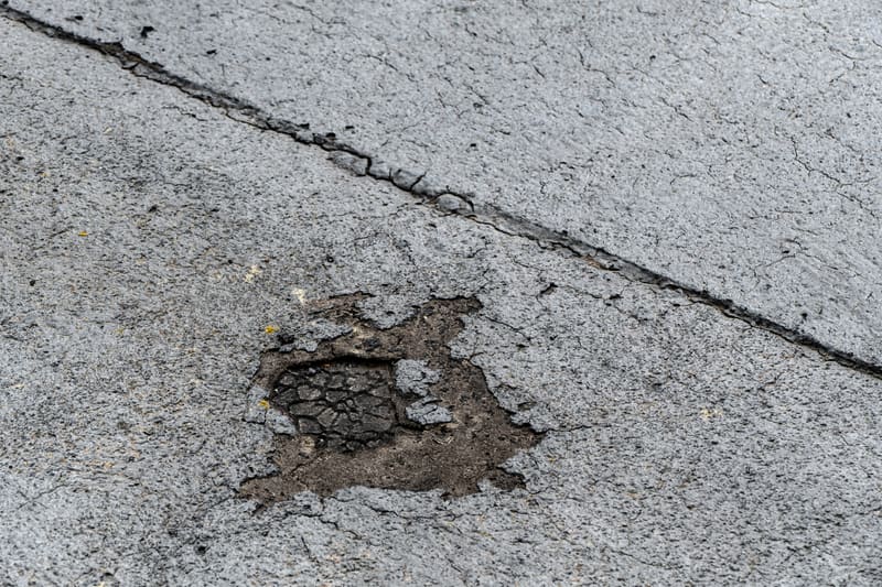 A blistered, broken patch in the surface of a flat roof